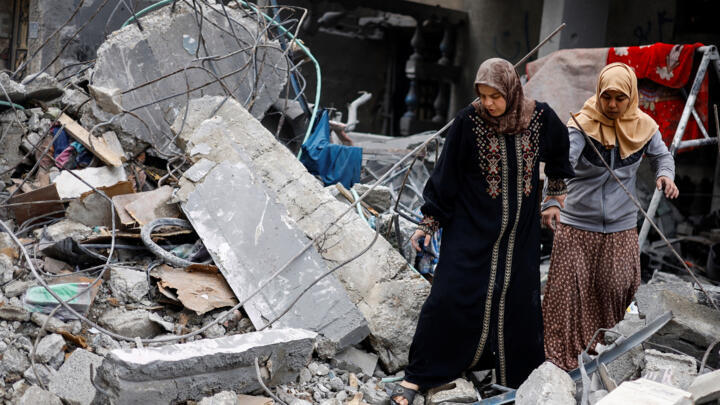 Palestinians inspect the site of an Israeli strike on a house in Rafah, in the southern Gaza Strip, on March 24, 2024.